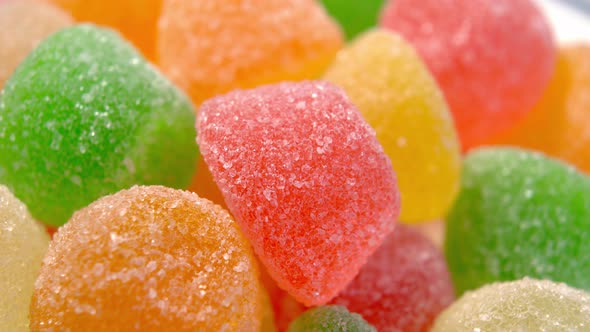 Multicolored marmalade candy with sugar close-up. Gelatin sweet snack. Macro