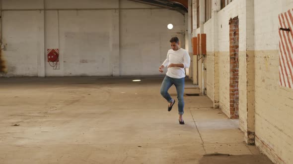 Male dancer in an empty warehouse