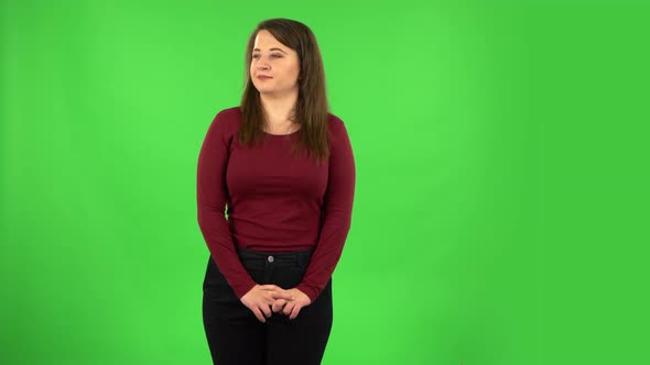 Portrait of Pretty Girl Is Daydreaming and Smiling Looking Up. Green Screen