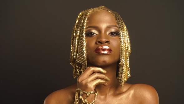 Studio Portrait Of Surreal African American Woman With Golden Faceart