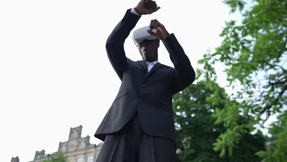 African American Man in Suit Boxing Shadow Standing Outdoors in VR Headset