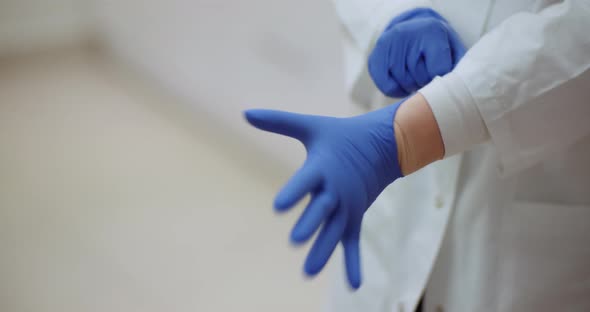 Close Up of Female Doctor Wearing Gloves