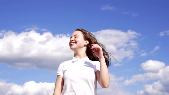 Happy Child Enjoy the Sun and Wind with Long Hair on Sky Background Enjoyment