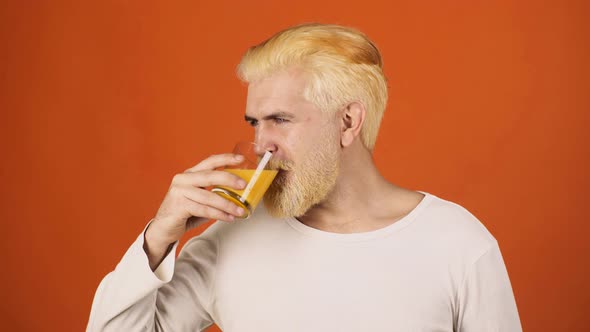 Funny Young Man Drinking Orange Juice