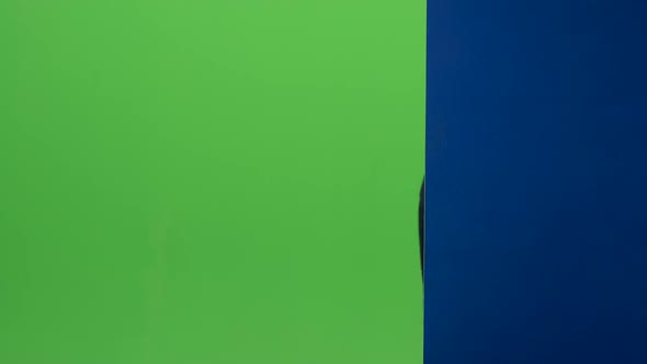 Child Boy in Glasses Peeps Out From the Blue Wall on a Green Screen