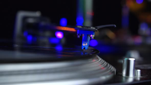 Professional DJ Gramophone Needle on Spinning Long Play Vinyl Record Close Up