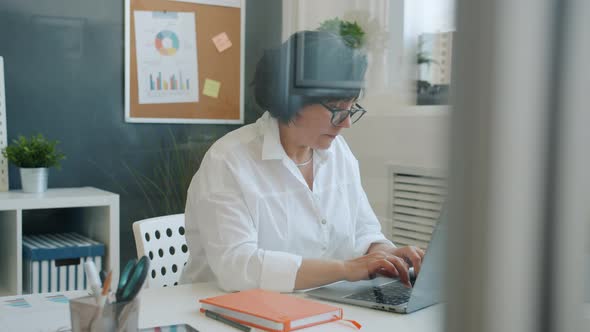 Serious Business Lady Using Laptop Typing Concentrated on Corporate Work in Office