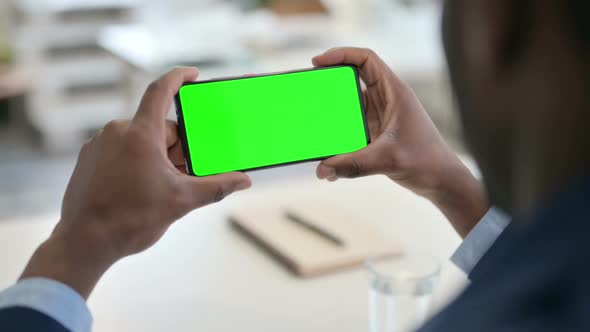 Businessman Watching Smartphone with Green Chroma Key Screen