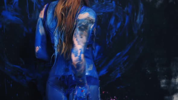 Seductive Young Woman Eroticly Dancing All in Blue Paint