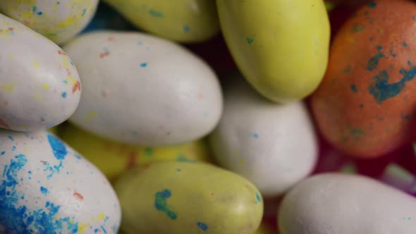 Rotating shot of colorful Easter candies on a bed of easter grass