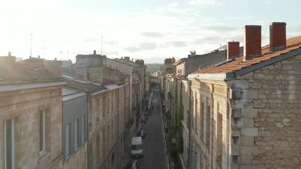 Aerial Rising Up Over Bordeaux, France Rooftops with Sunlight Hitting Buildings with Beautiful