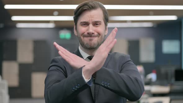 Portrait of Businessman Showing No Sign Arms Crossed