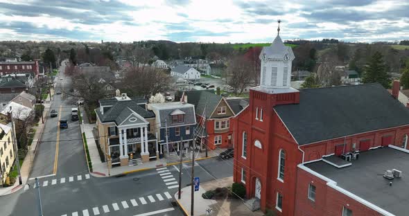 Religion in small town American. Christian church building on town square by homes in town. USA smal