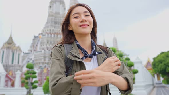 Portrait of Asian attractive woman backpacker travel in beautiful city