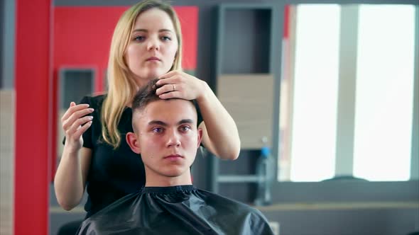 Young and Professional Hair Stylist Makes the Styling with Gel and Other Styling