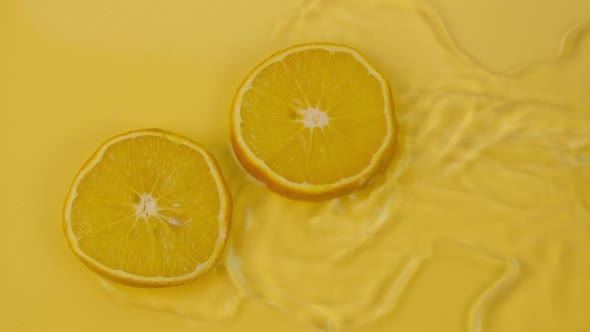 Water Flowing Slow Mo Around Citrus Orange Slices