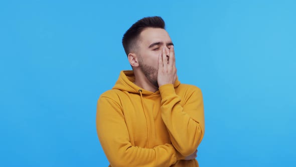 Expressive young man screaming and shouting over vibrant background.