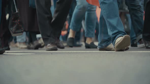 People Pedestrians Walks Across a Busy City Street