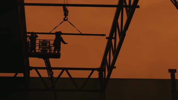 Workers are Assembling a Metal Frame for the Roof of an Industrial Building