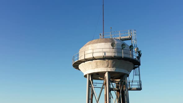 Water tower - elevated liquid storage tank. Metal reservoir for compressed gases hazardous chemicals