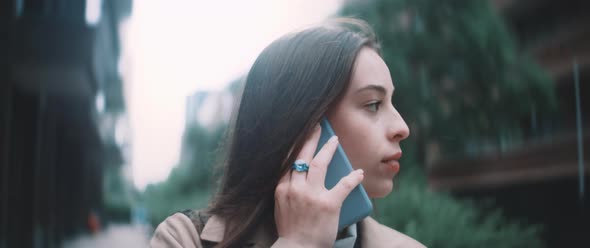 Woman takes a phone call while walking