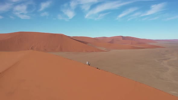 The Dune 45 filmed from above with a drone. The sun is shining and several people are walking over t