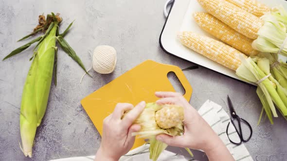 Time lapse. Step by step. Shucking organic corn to make Mexican corn on the cob Elote.