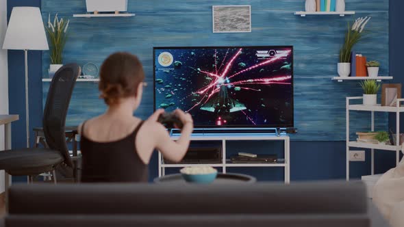 Young Woman Holding Wireless Controller Playing Action Space Shooter Disappointed Because Losing