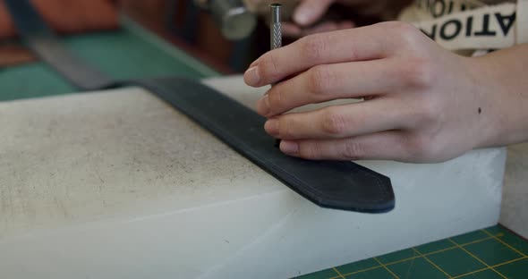 Close Up Shot of Specialist Working with Leather Female Hands of a Craftswoman Make Holes in a