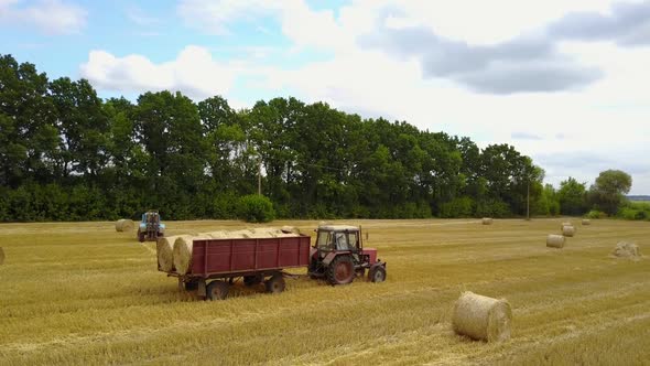 Tractor Loading Hay Bales