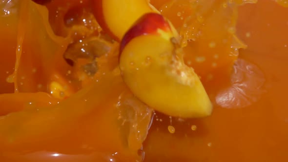 Slices of Peach Fall Into Juice