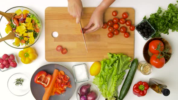 Woman Chopping Tomato with Kitchen Knife at Home