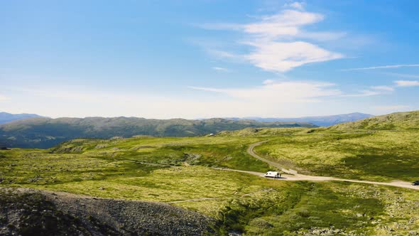 Camper Van Positioned On The Roads Of Green Mountains At Rondane National Park In Norway. - Aerial W