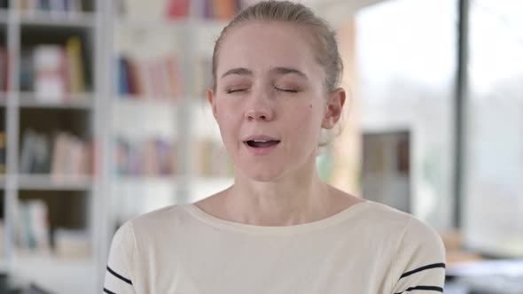 Portrait of Sleepy Young Woman Yawning