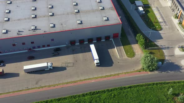 Aerial view of warehouse with trucks.
