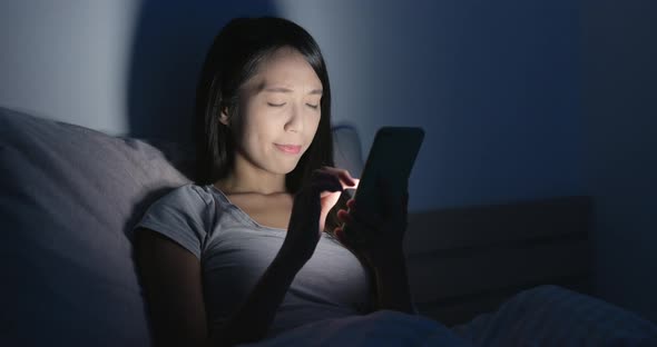 Woman using cellphone and pain of eye