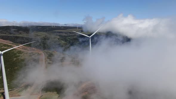 Wind power plant in the clouds, aerial view