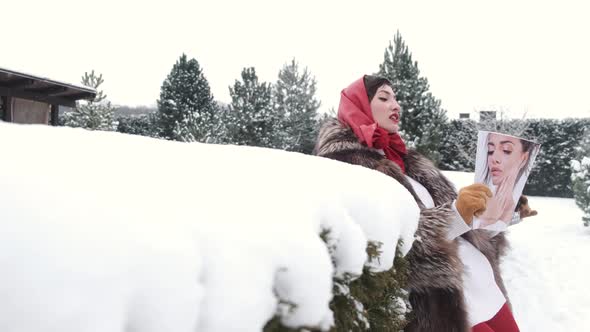 Stylish Woman in Fur Coat and Head Scarf in Winter Backyard