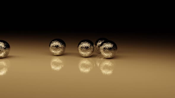 Mechanical Collision Of Golden Balls On A Glossy Surface.