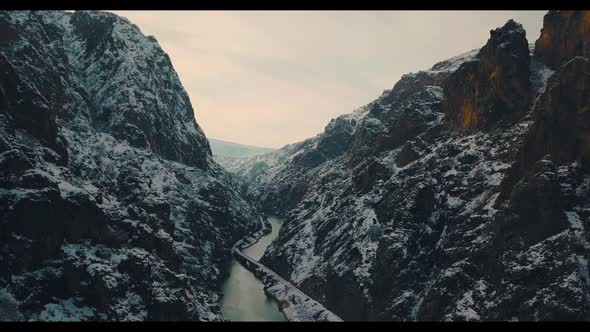 aerial view of train between snowy mountains