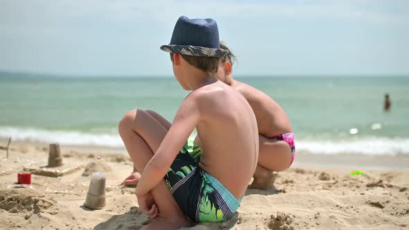 Kids Playing in Sand on Seaside