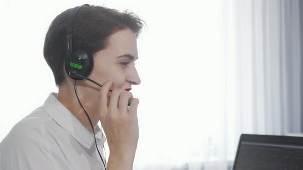 Charming Young Woman Smiling To the Camera While Working at Call Center