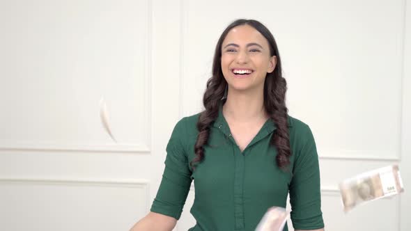 Indian girl throwing money in air