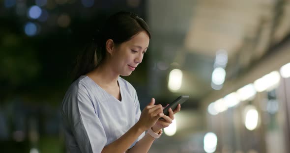 Woman work on cellphone at night