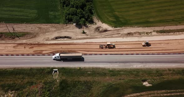 Road Construction Site with Machinery, Bulldozer, Excavation From Above.  Video, Aerial View