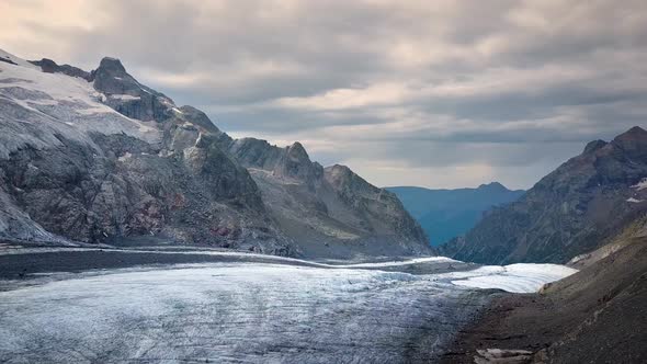 aerial travelling on a swiss glacier in the swiss alps on a cloudy sunset