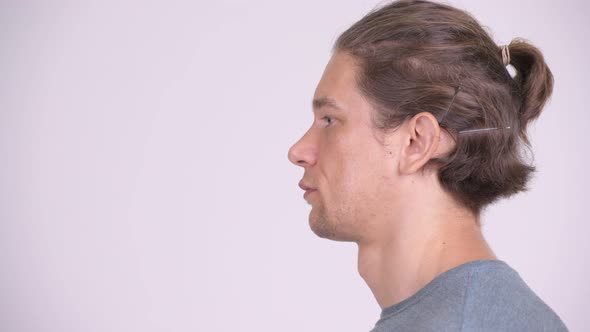 Head Shot Profile View of Handsome Man Against White Background