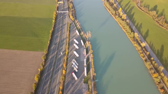 Top down aerial view of highway interstate road with fast moving traffic and parking lot