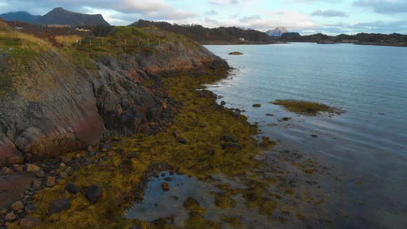 Drone orbits around the shore in norway. Mountains and ocean