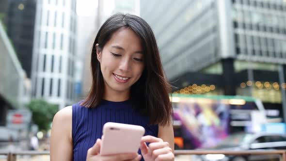 Woman using cellphone at Hong Kong city